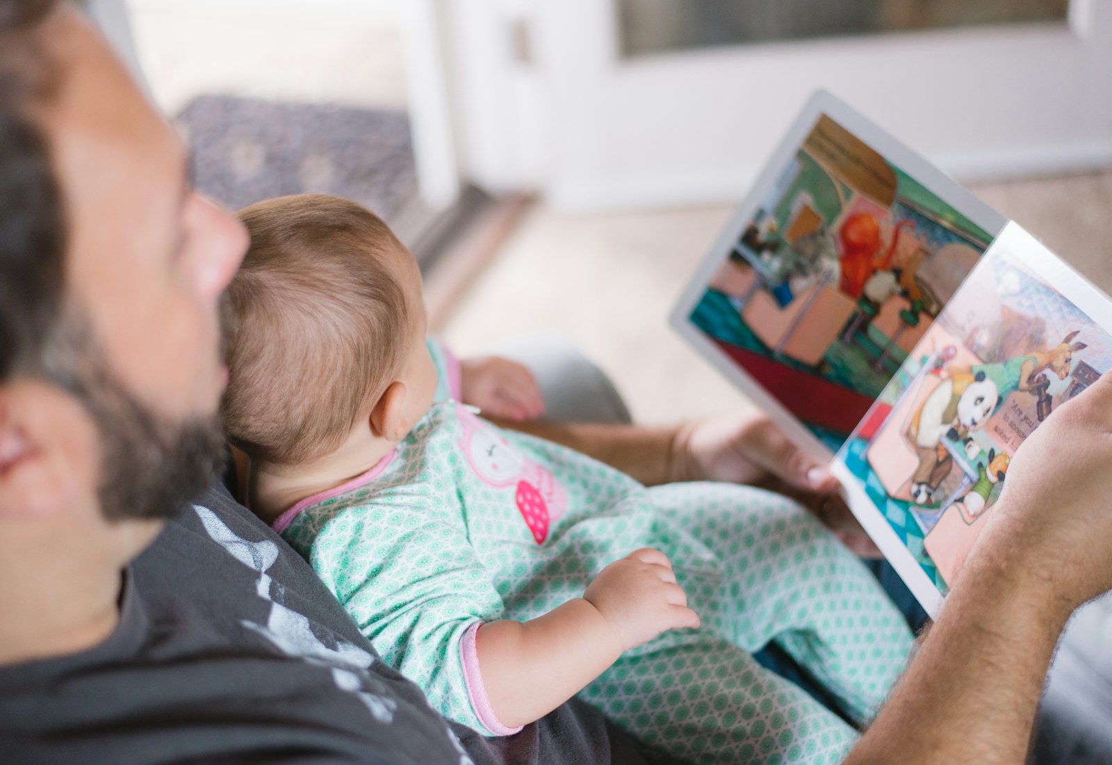 A parent reading with a baby